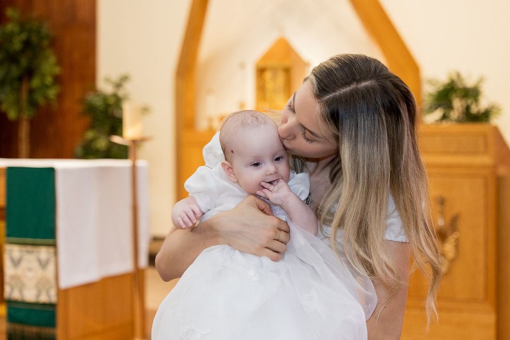 A montage of tender moments between parent and baby in a warmly lit room with wood paneling and natural decor.