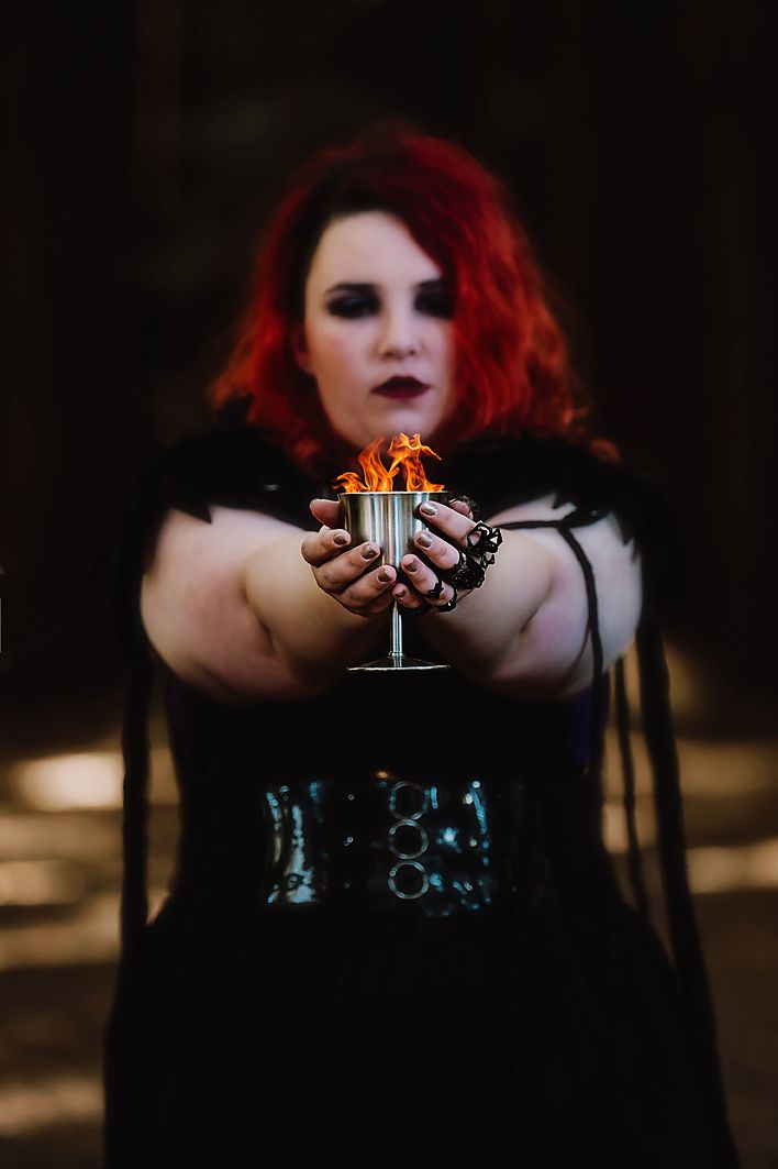 Dark moody portraits showing hands holding a small glass with red lighting effects and dramatic shadows.