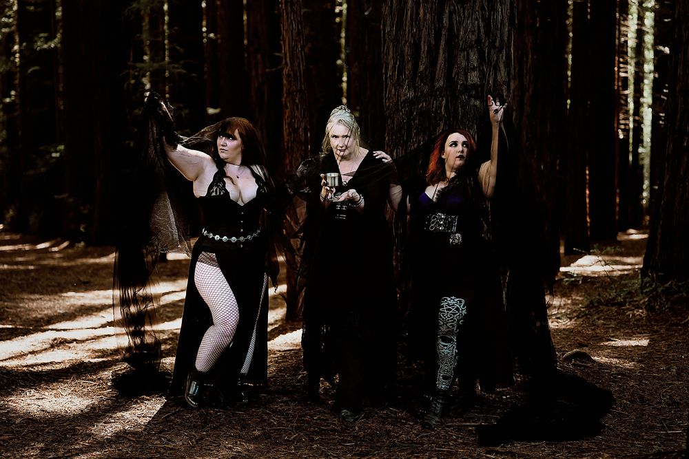 Three women celebrating themselves and their connection to nature during a goddess photo session in the warburton redwoods