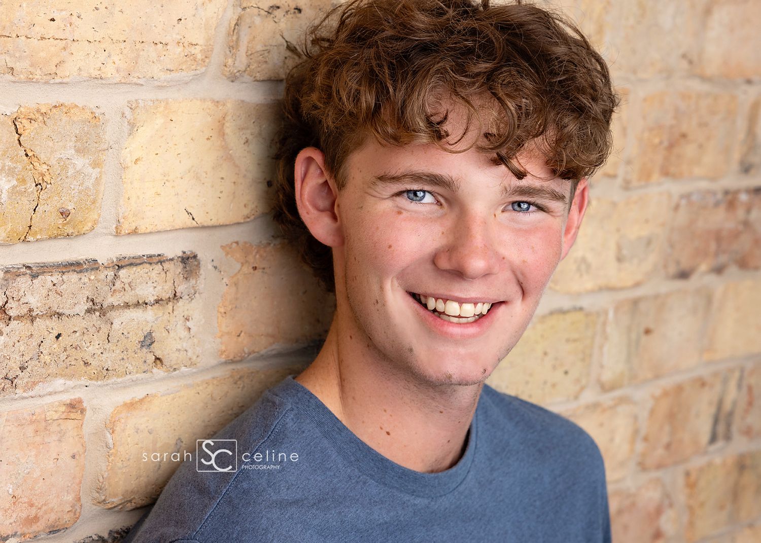 A headshot series of someone laughing against a rustic brick wall background.