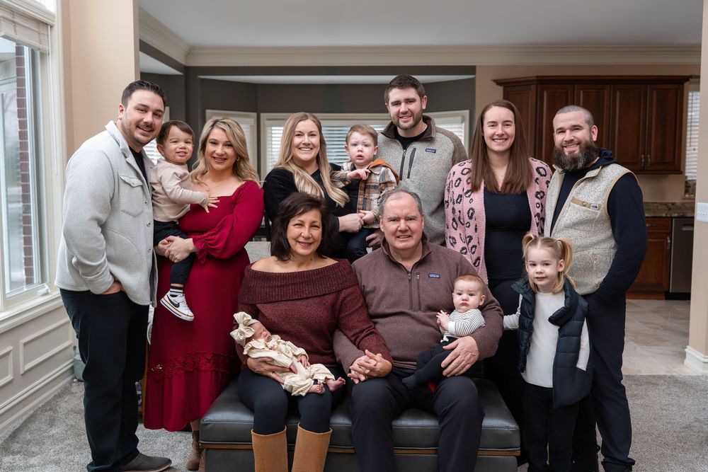 A series of casual family group photos taken indoors showing people gathered together and smiling at the camera.