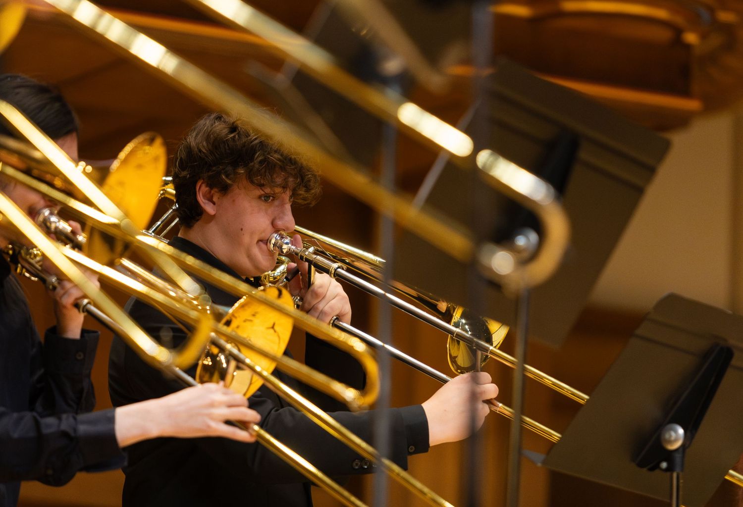 A trombonist performs on stage.