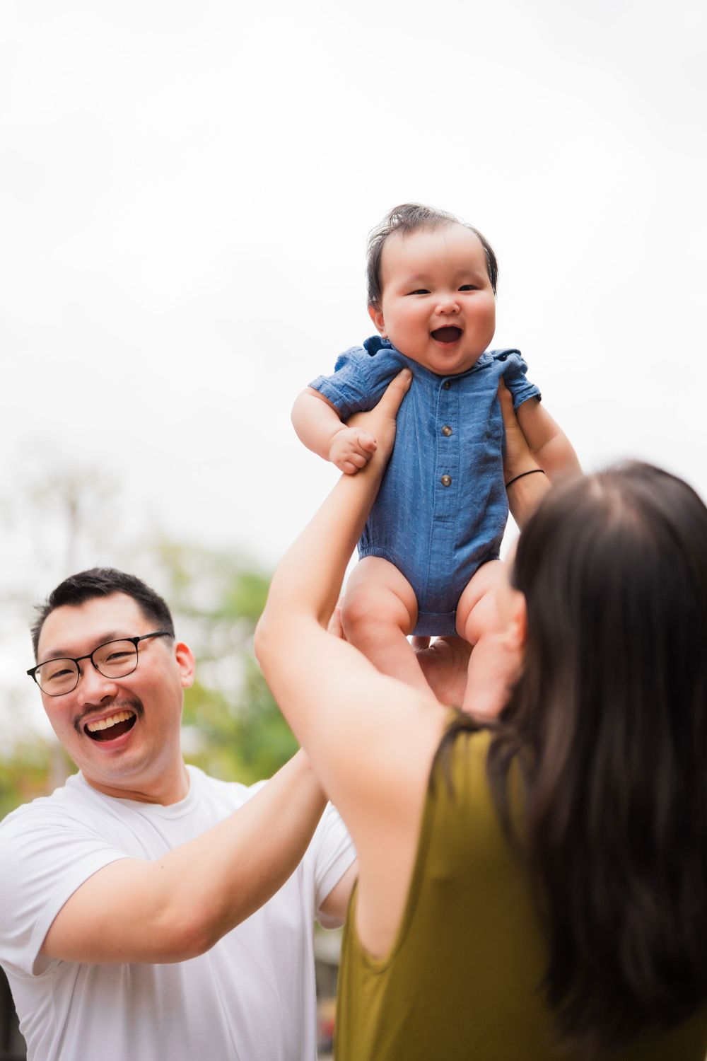 Parents holding up a newborn baby at Huashan 1914 Creative Park in Taipei City.