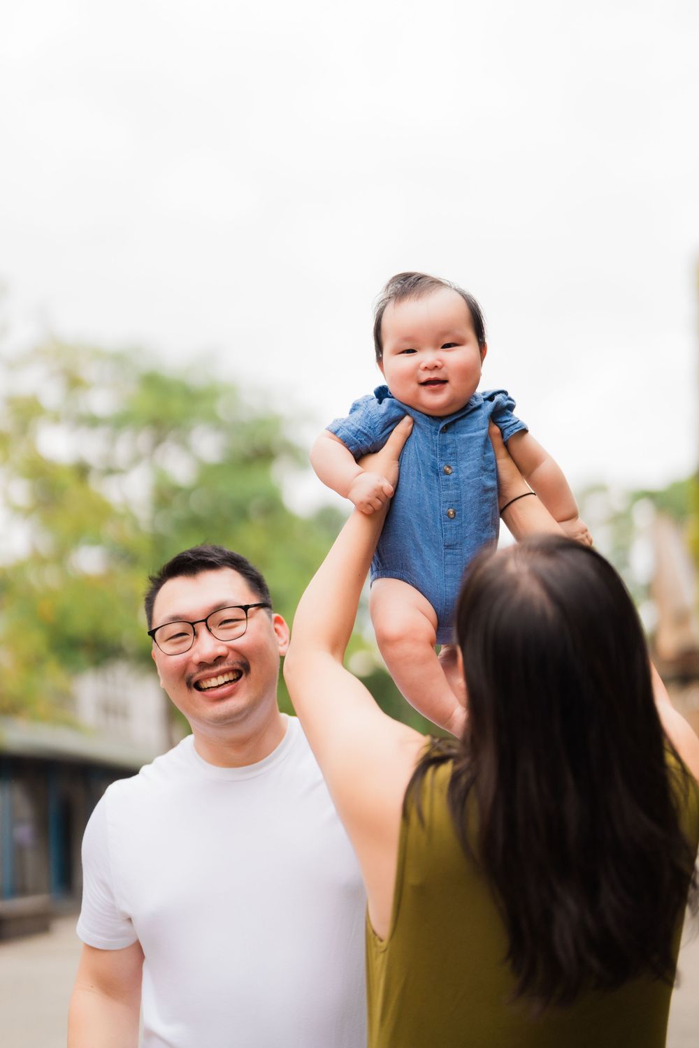 Parents holding up their newborn baby at Huashan 1914 Creative Park in Taipei City.