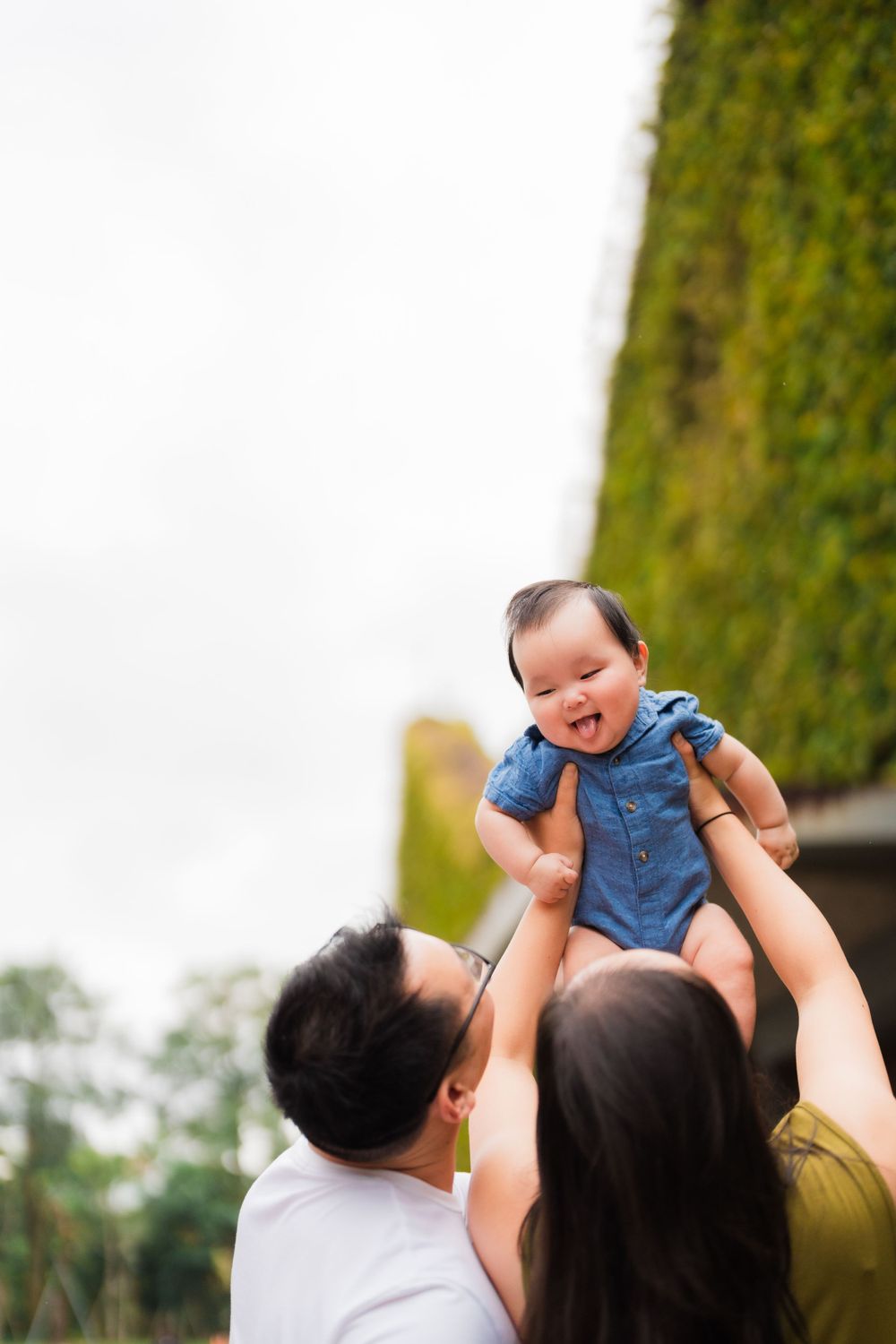 Parents holding up their newborn baby at Huashan 1914 Creative Park in Taipei City.