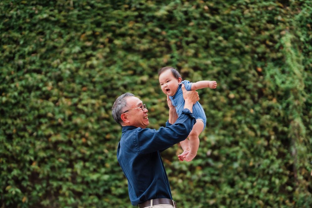 Grandpa playing with a newborn baby at Huashan 1914 Creative Park in Taipei City.