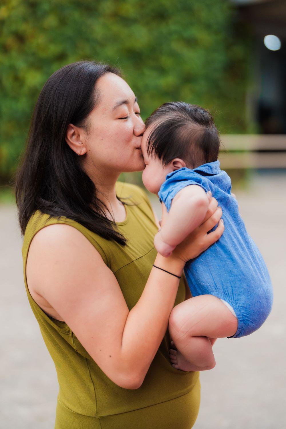 Mom kisses baby on the head at Huashan 1914 Creative Park in Taipei City.