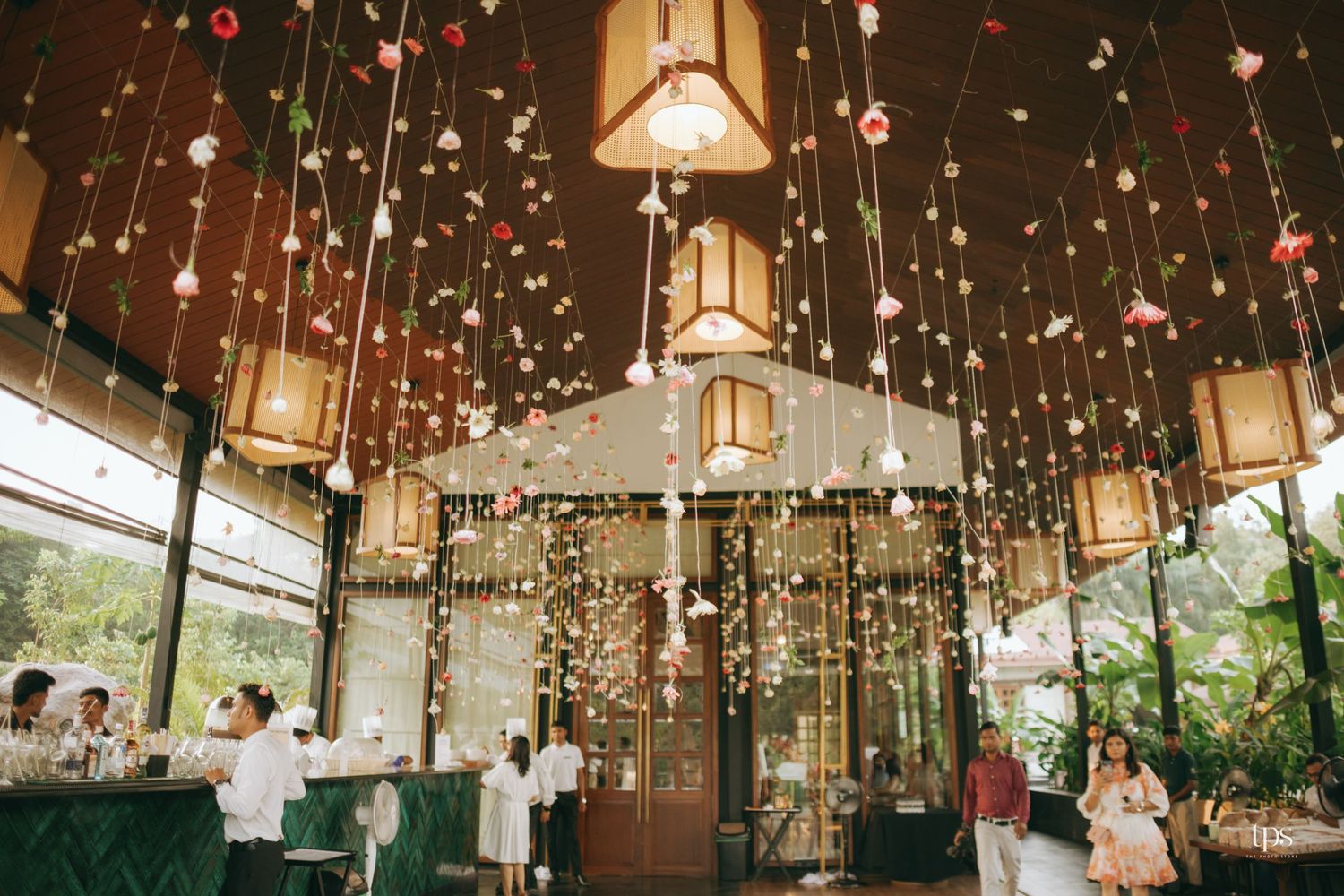 Wedding venue ceiling decorated with romantic hanging lights and crystal decorations.