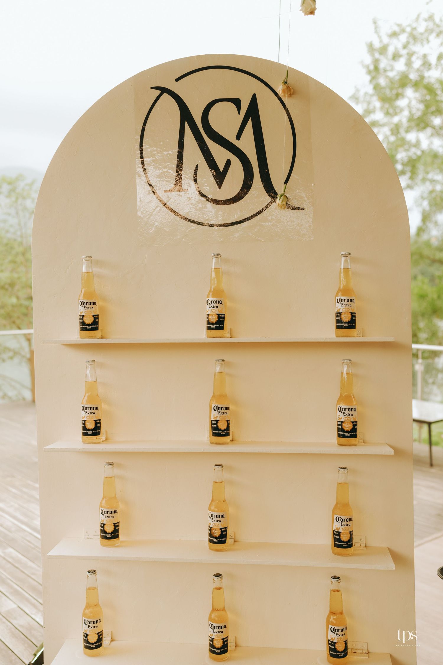 Elegant display shelf with Corona beer bottles arranged in arched alcove design.