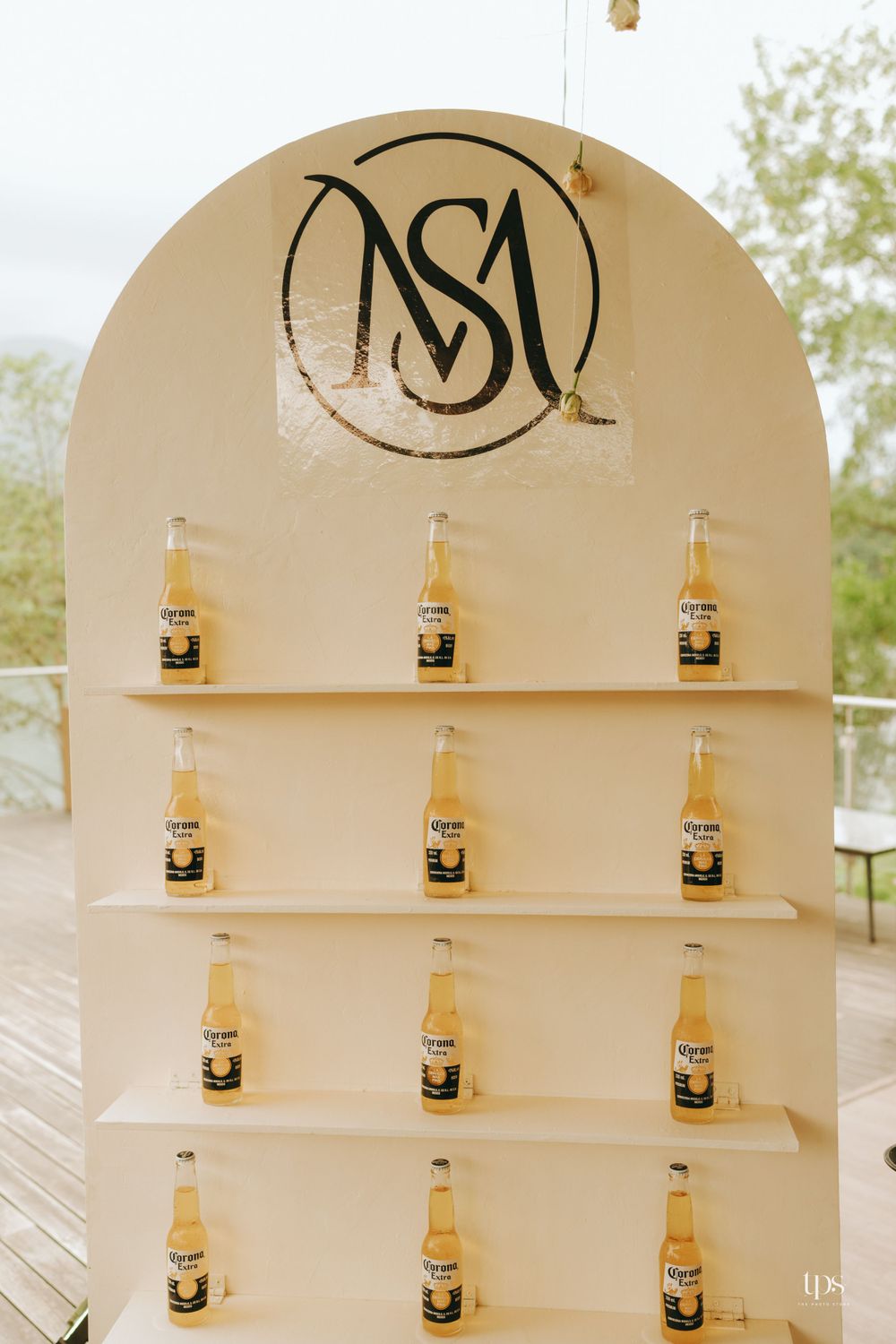 Elegant display shelf with Corona beer bottles arranged in arched alcove design.