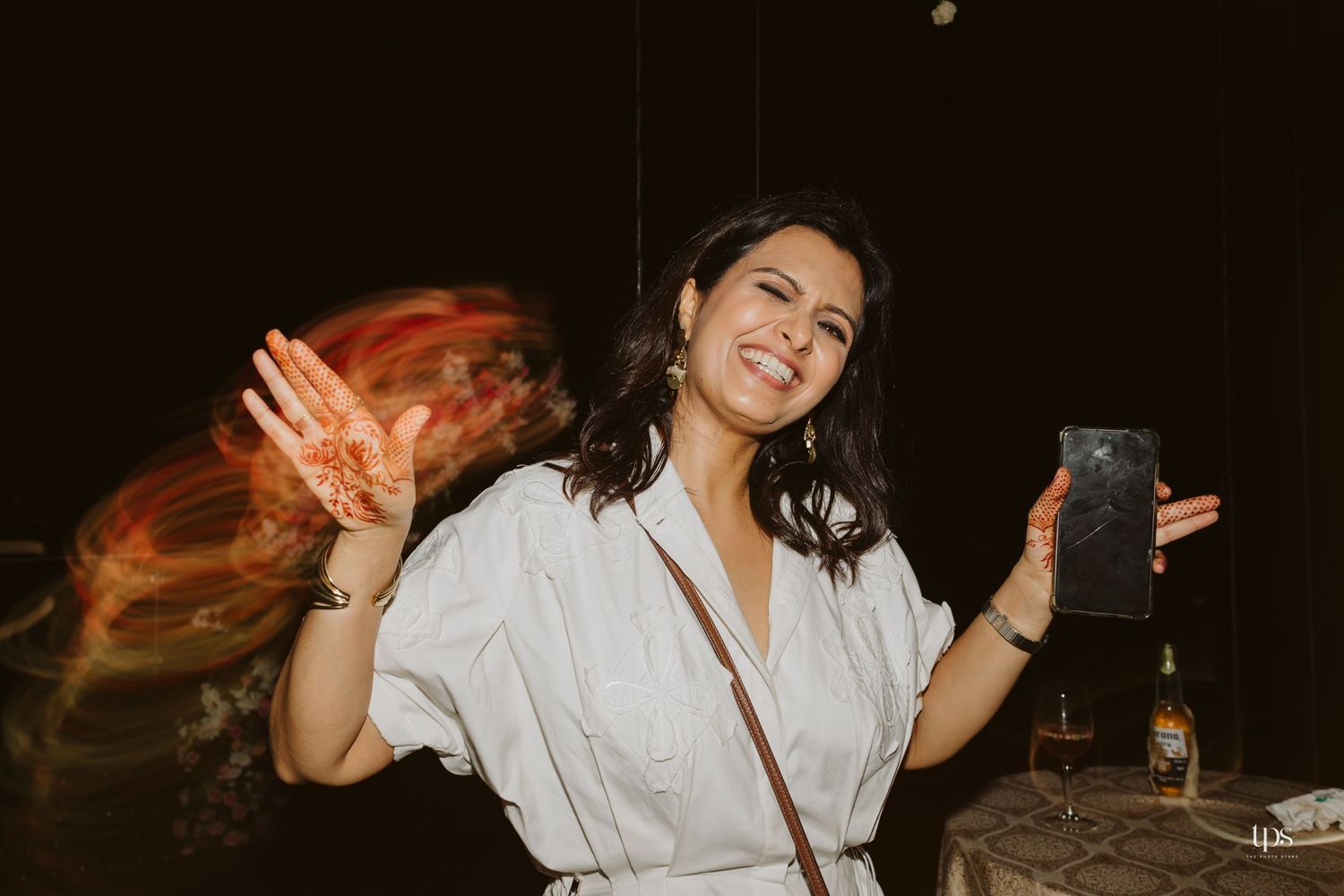 Energetic dance party scene with people celebrating in a dimly lit venue.