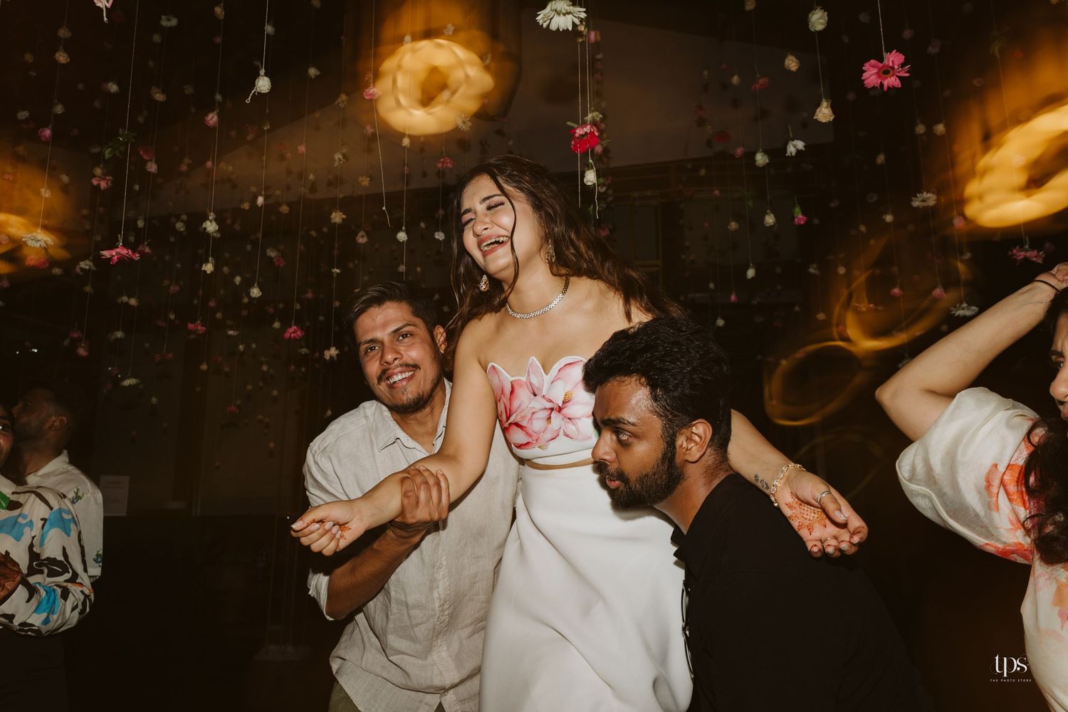 Lively indoor celebration with dancing and festive lighting effects.