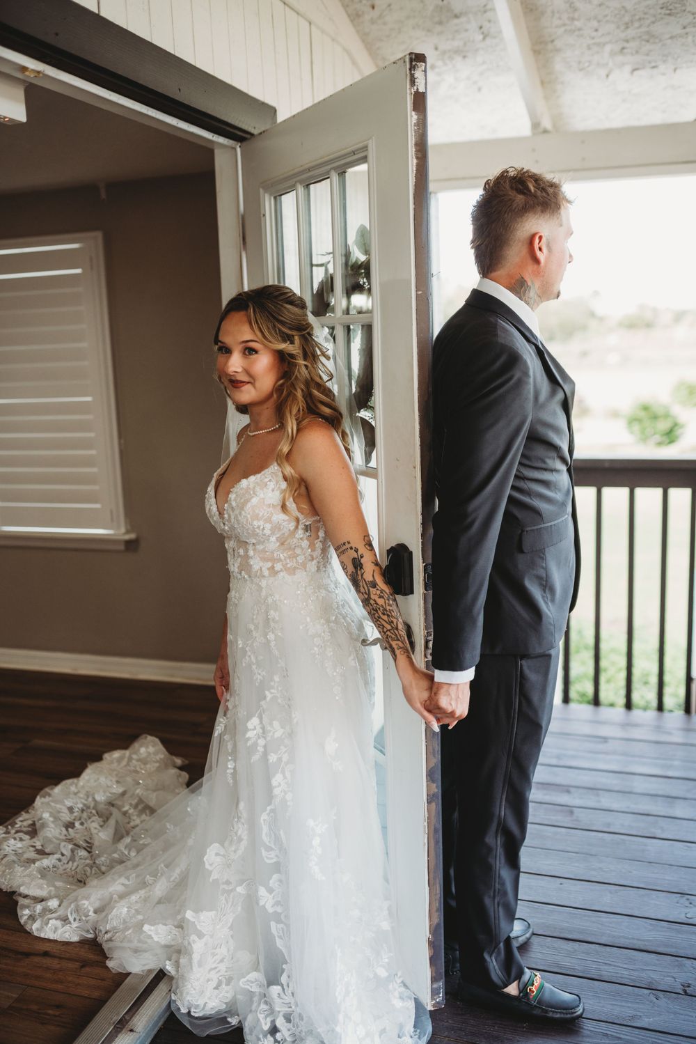 First look moment between couple on wooden deck before wedding ceremony.