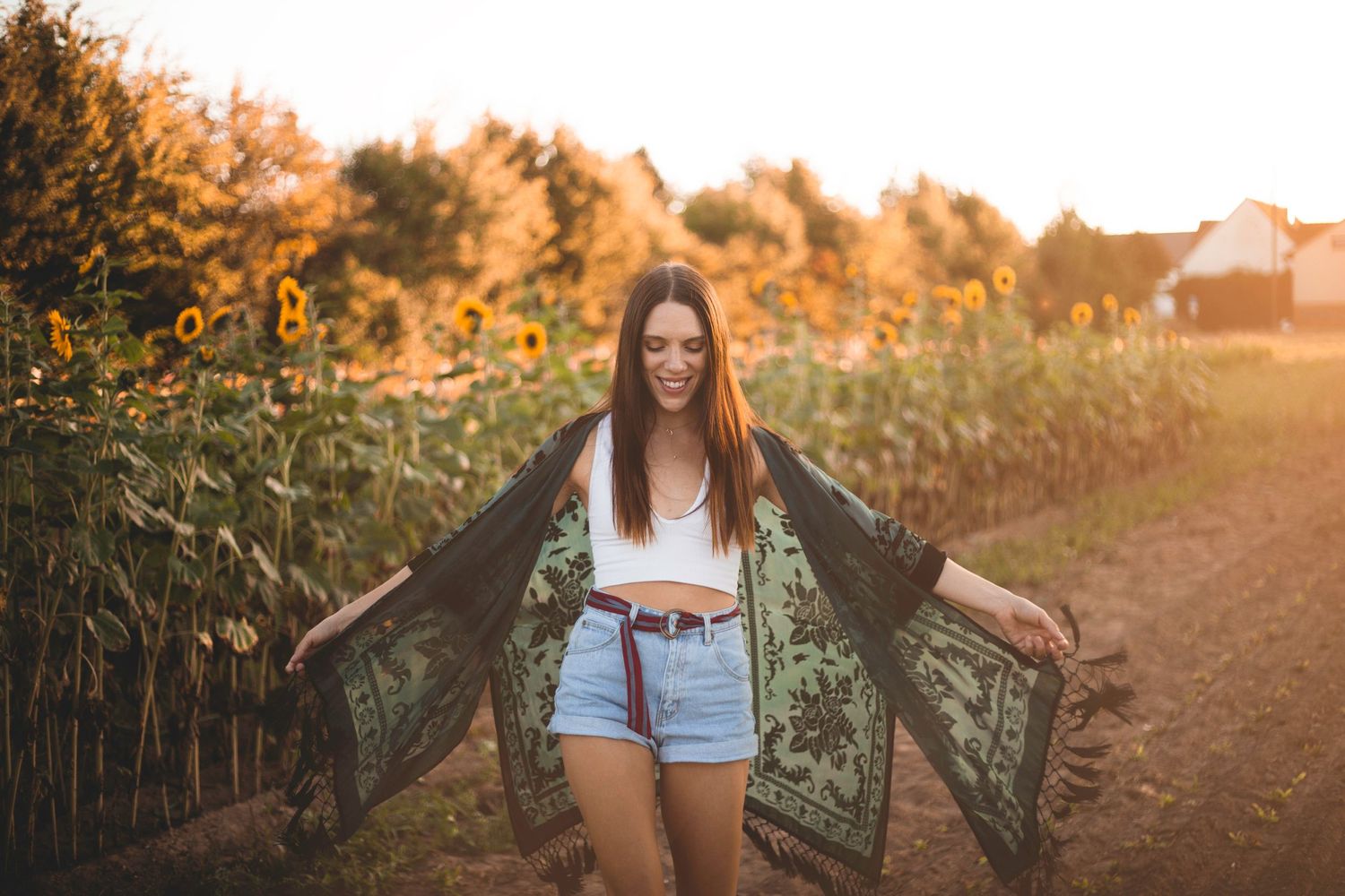 Photo of female model in a sunflower field at sunset