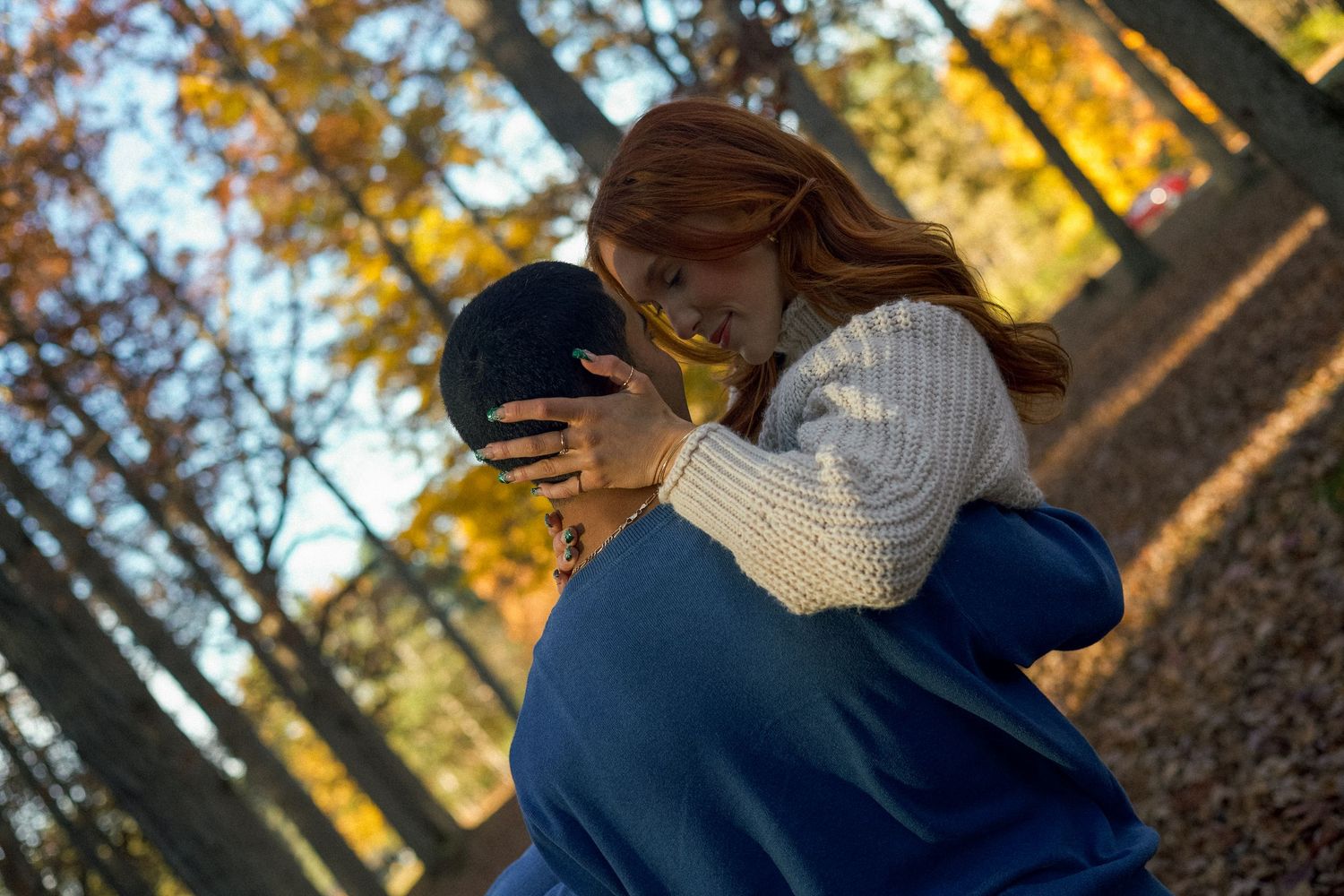 A couple plays and walks along the coast line on the beach during couples photos in Saugatuck, Michigan.