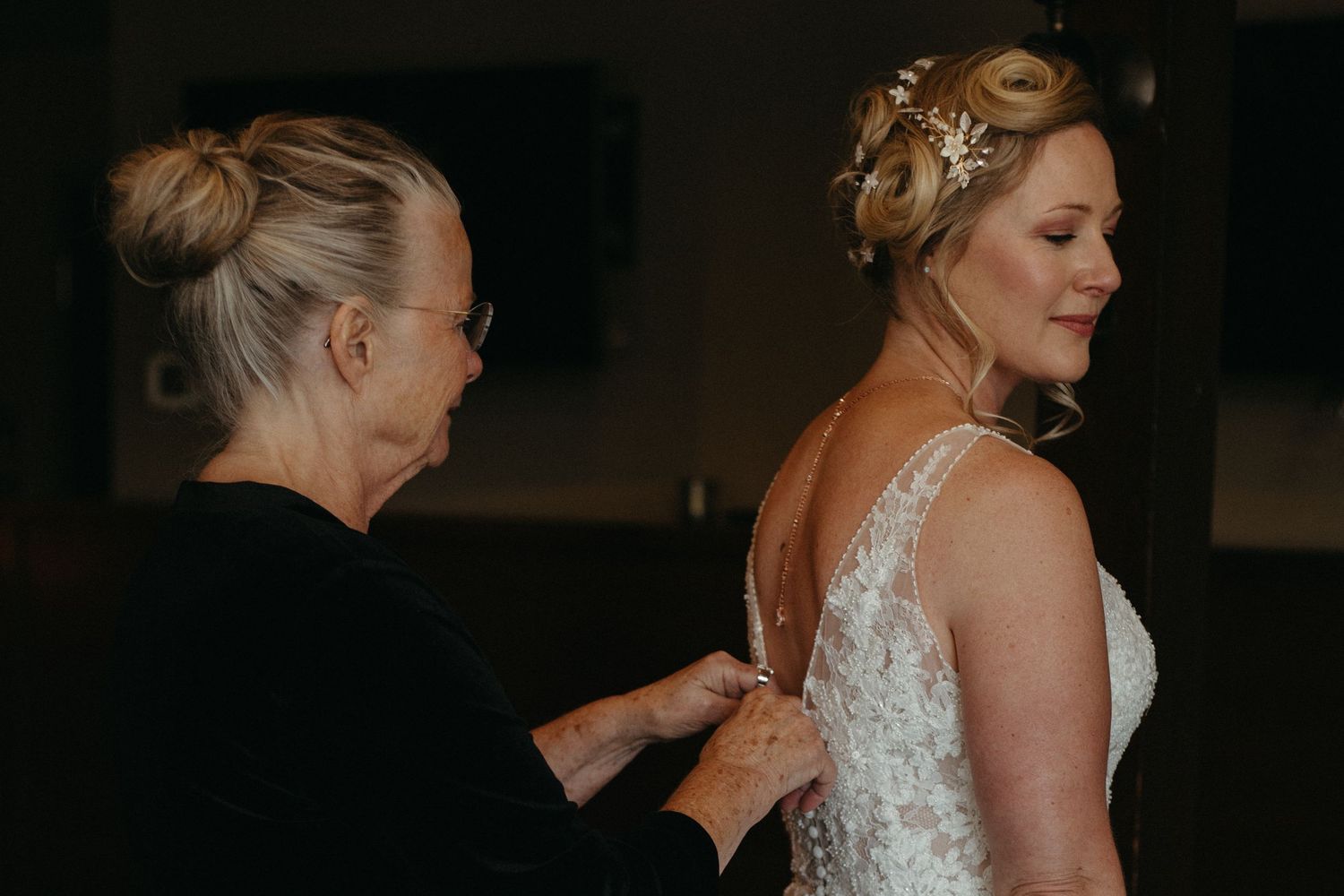 A wedding dress with delicate lace straps and empire waist silhouette is displayed.