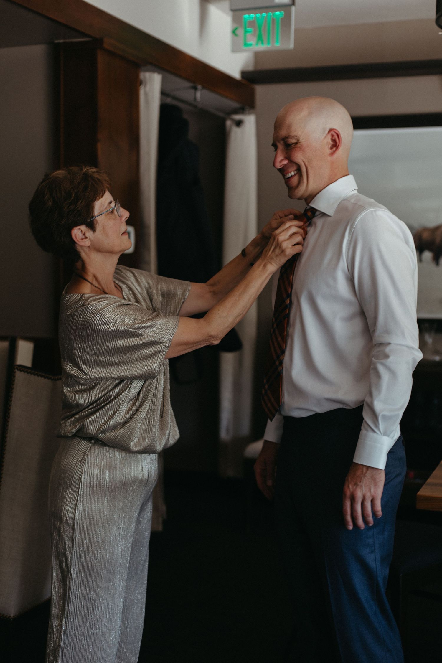 Two people share an emotional moment during wedding preparations.