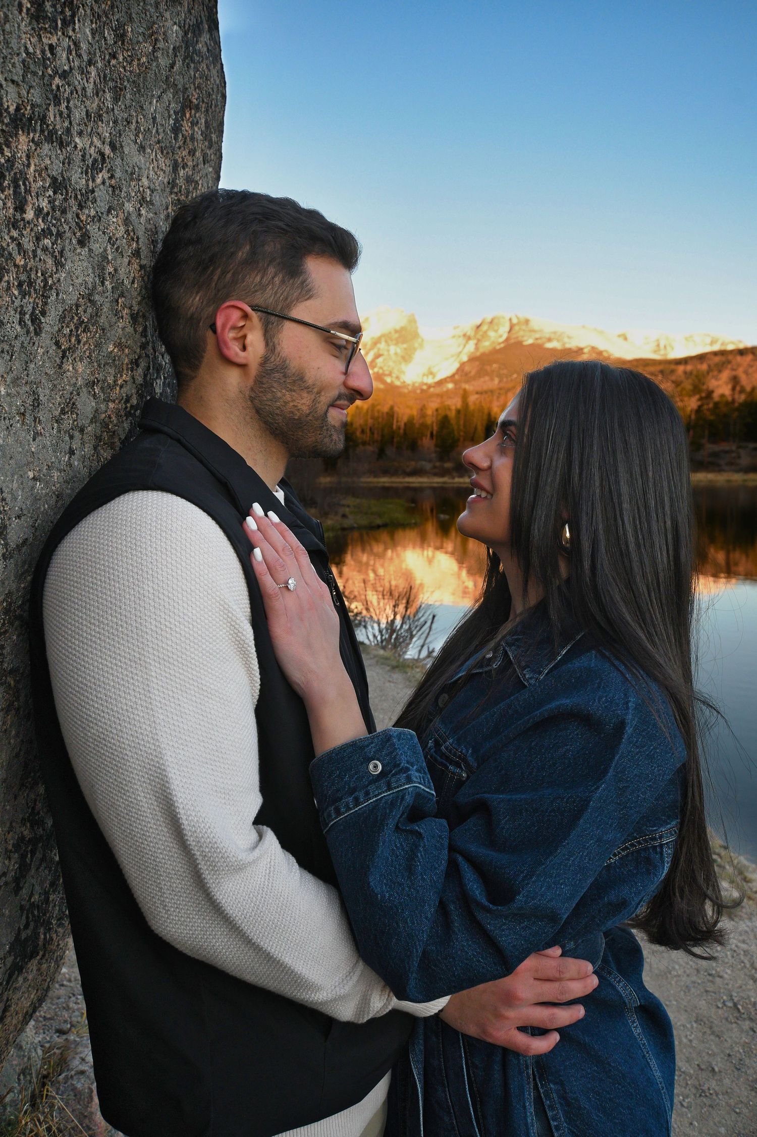 Couple embracing after his sunrise proposal to her at Sprague Lake in Rocky Mountain National Park. Photographer: Pixcapades