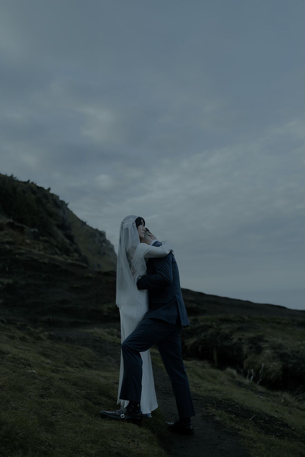 A bride and groom embrace on a misty hillside during their Elk Flats Trail elopement