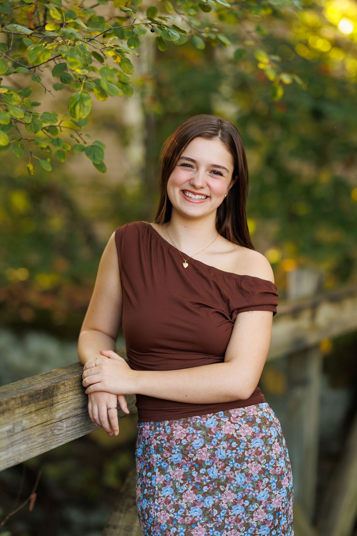 High school senior portrait captured by Tom Forrest Photography on a small bridge at the First and Main area in Hudson, Ohio.