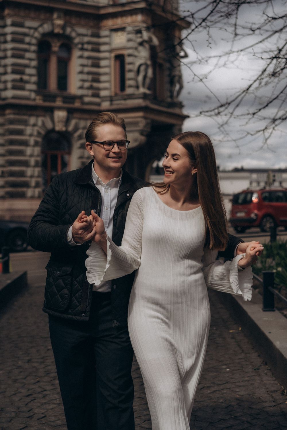 Engaged couple walking through Helsinki city centre during a natural urban engagement photoshoot