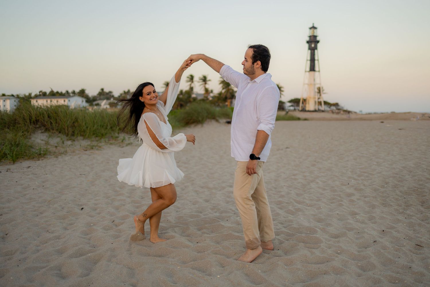 Pompano Beach engagement session featuring a private beach path and lighthouse views