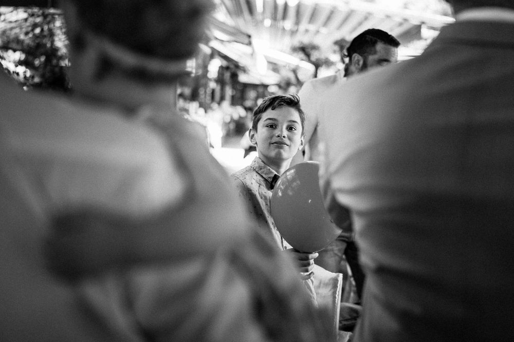 Black and white photo showing someone looking down at a crowded dining table from a unique angle.