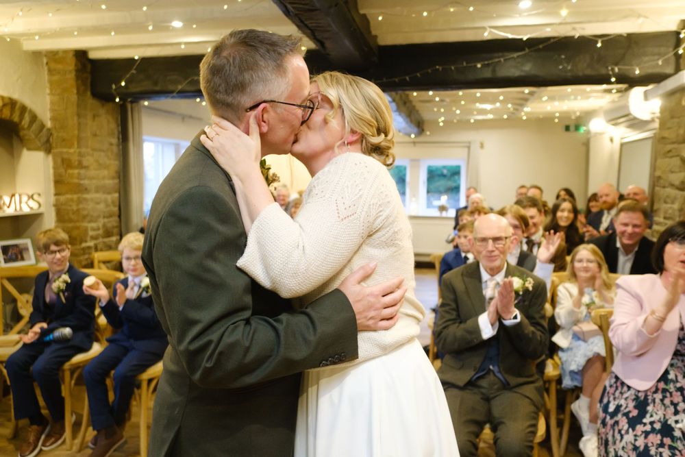 Bride and Grooms first kiss at the black horse in Clifton