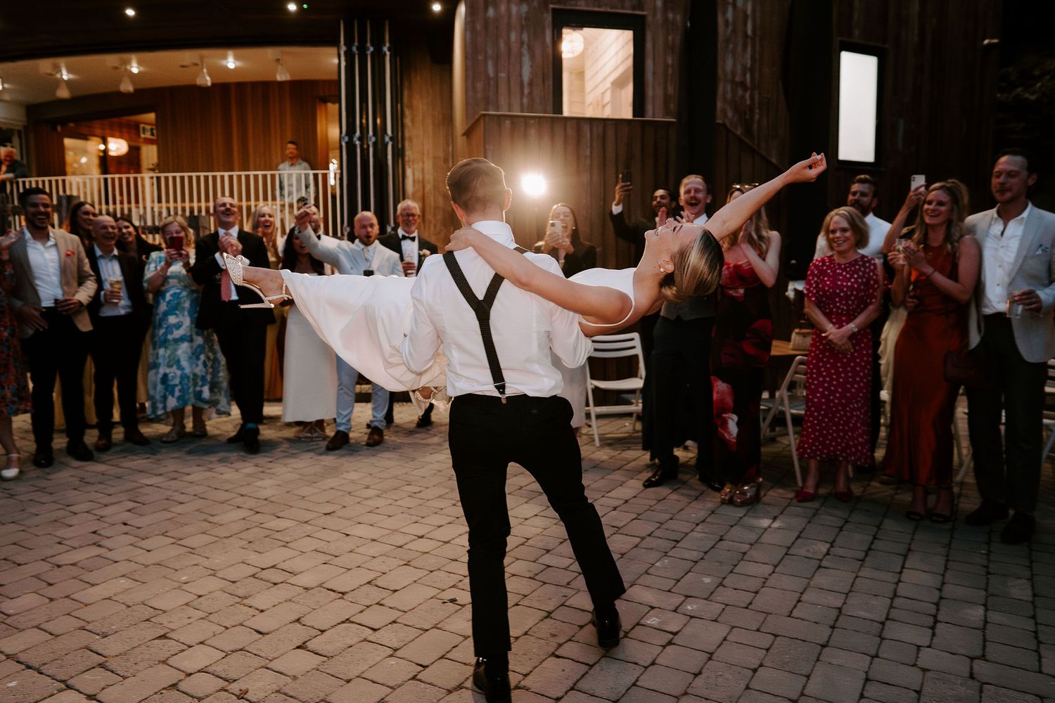 groom lifting bride in first dance at tunnels beach wedding venue in north devon