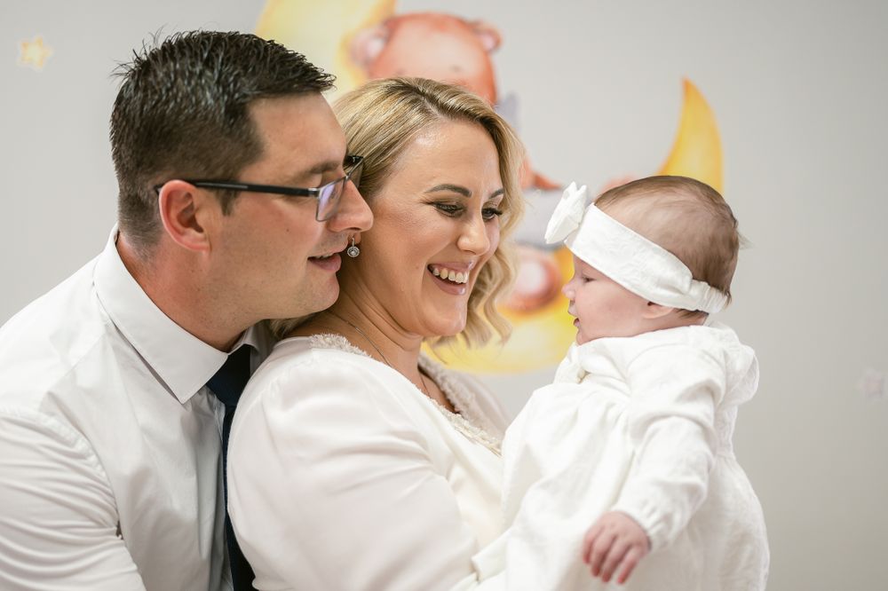 A joyful family moment in white attire sharing smiles and laughter together.
