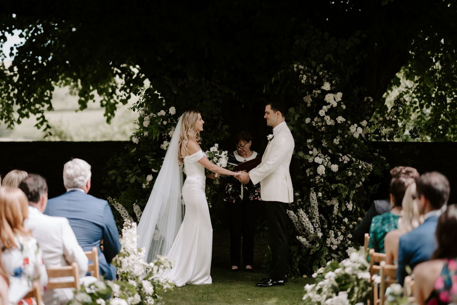 bride and groom holding hands and smiling during ceremony at Hamswell house in bath
