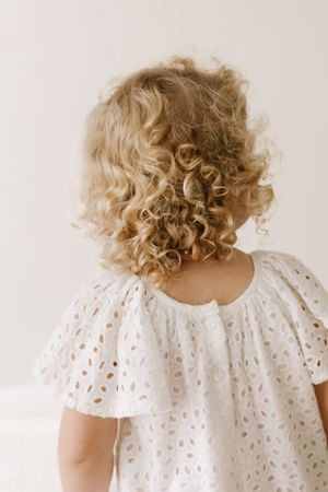 White eyelet dress with puff sleeves shown from multiple angles on light background.