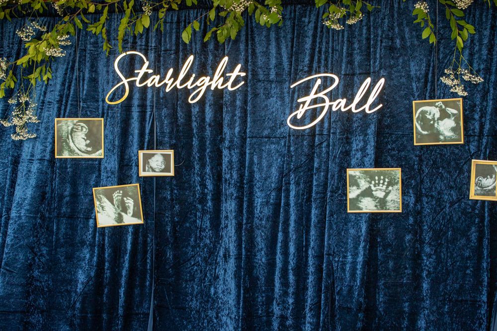 Blue velvet backdrop with 'Starlight Ball' text and vintage photos displayed.