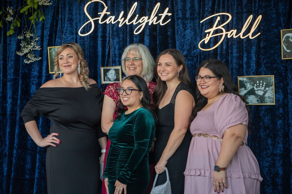 Elegant blue curtain backdrop with 'Starlight Ball' text display at formal event.