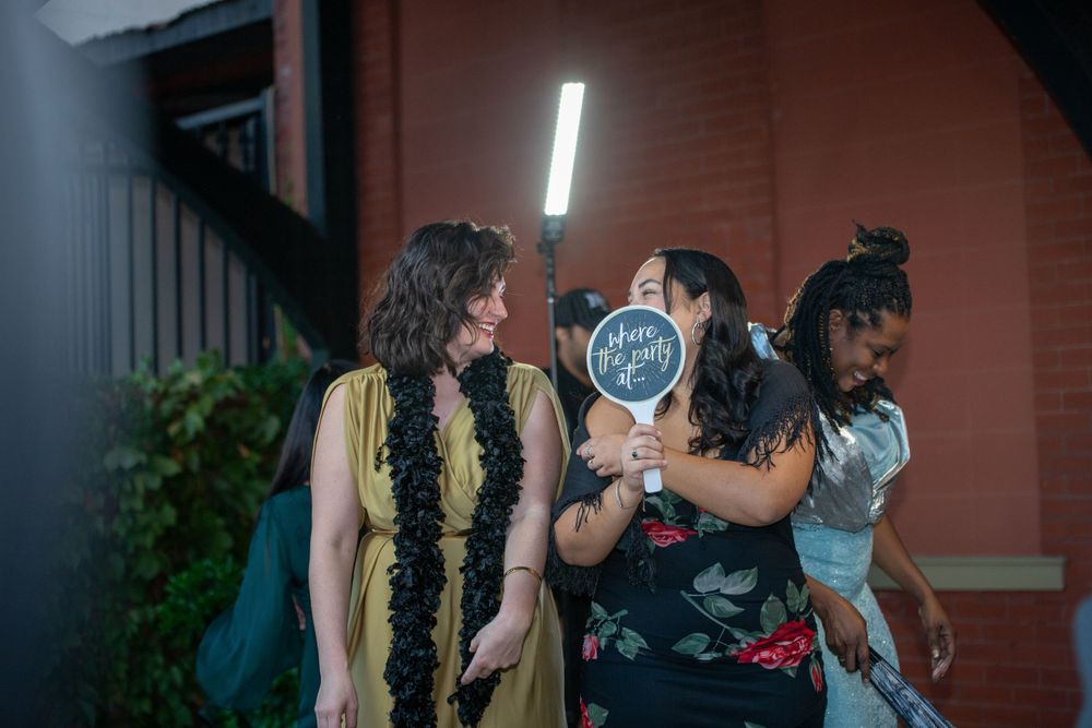 Guests mingling at nighttime event with decorative lighting.