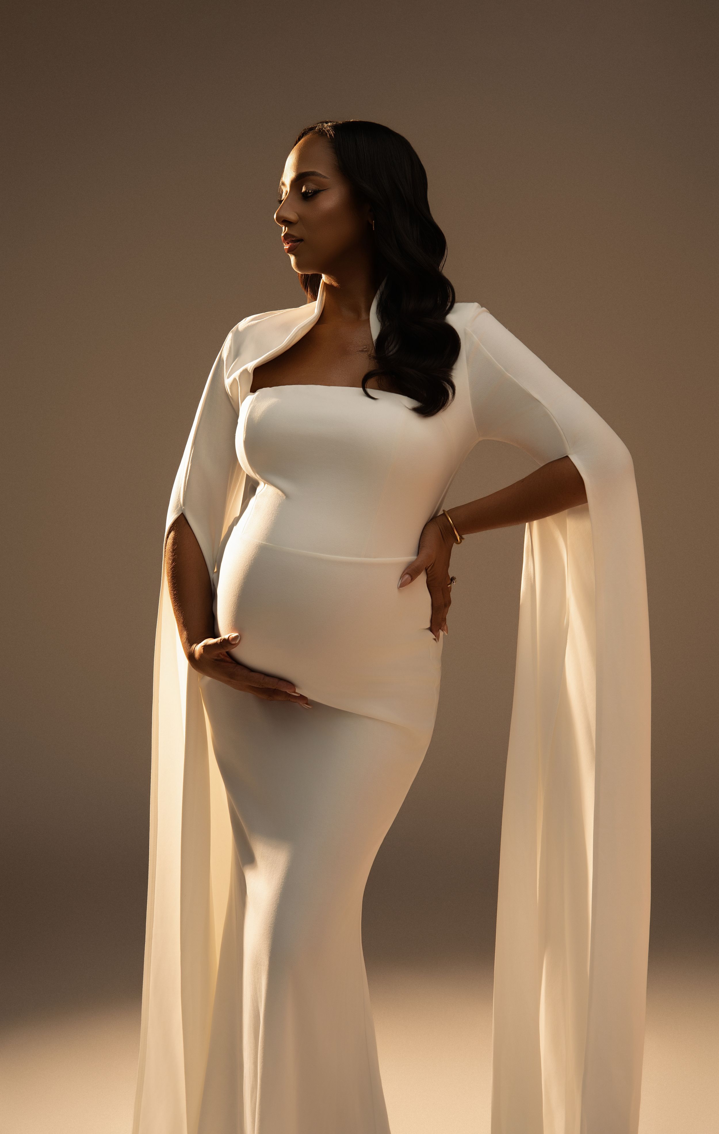 Miami Maternity photographer Black and white artistic maternity portrait featuring an expectant mother draped in flowing fabric
