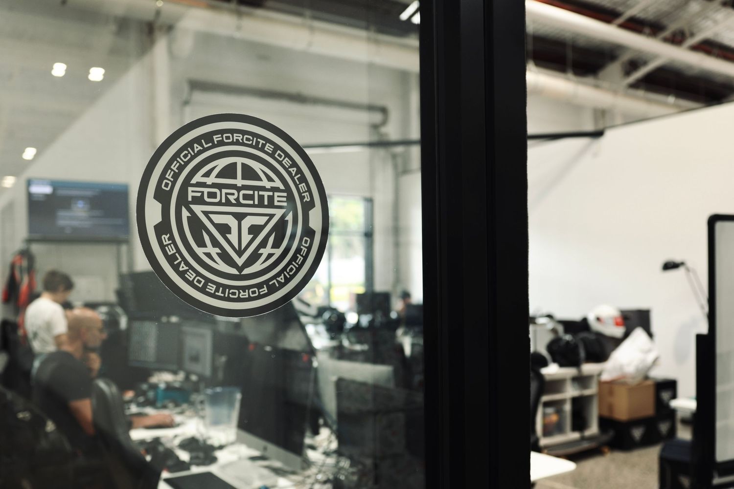 Modern office interior with workstations and company branding on walls.