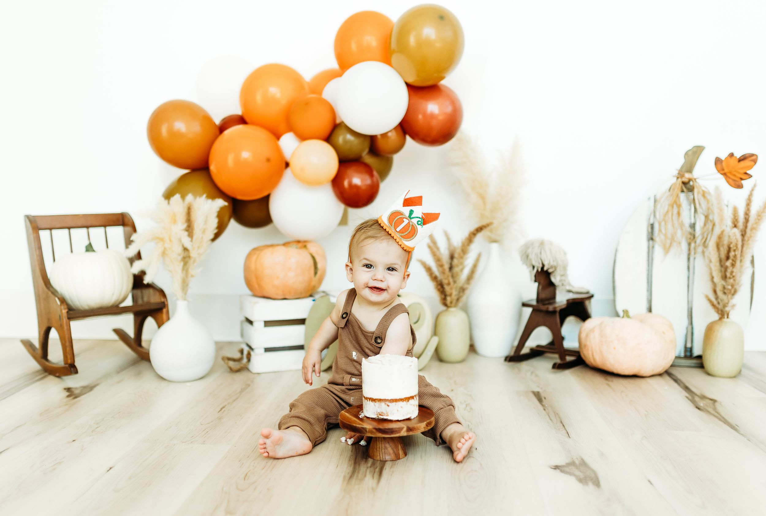 A series of orange and white balloons arranged in a creative timeline photo sequence against a white background.