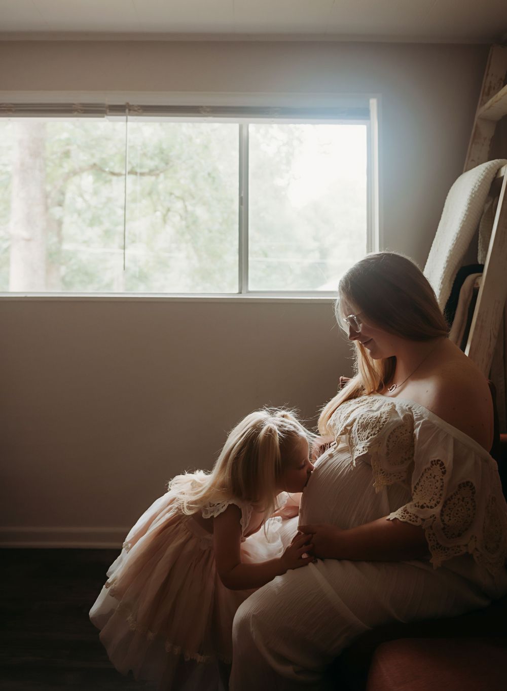 A series of soft, moody images showing a person in a flowing white dress sitting by a window in natural light.