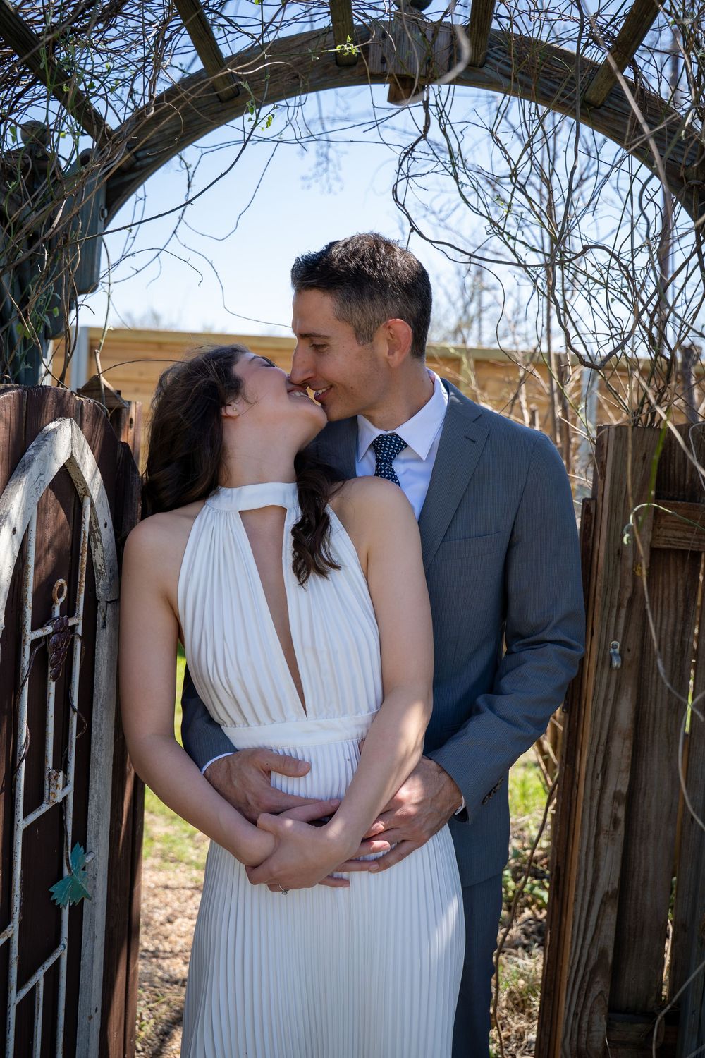 Series of romantic wedding photos showing a couple in formal attire sharing intimate moments against a rustic fence backdrop.
