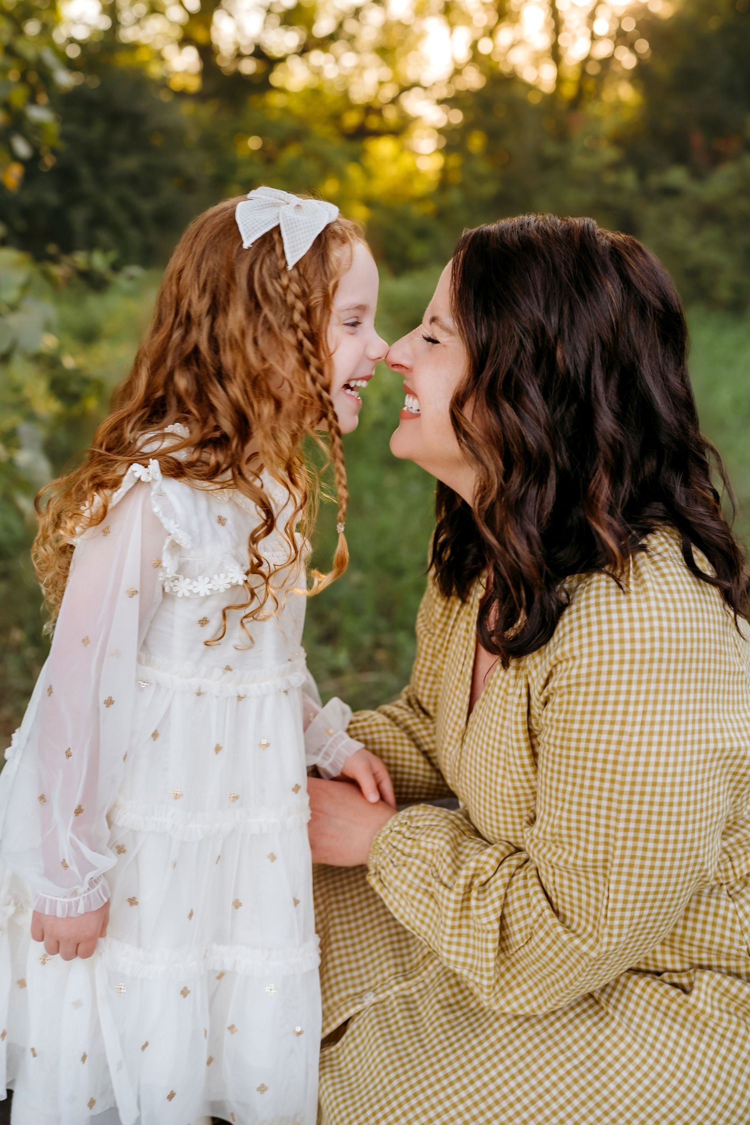 A series of tender moments captured at sunset showing a parent and child in matching yellow gingham and white outfits.