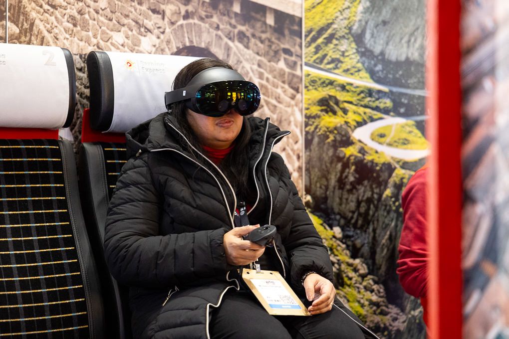 A female using an interactive headset at the 2025 WTM in London.
