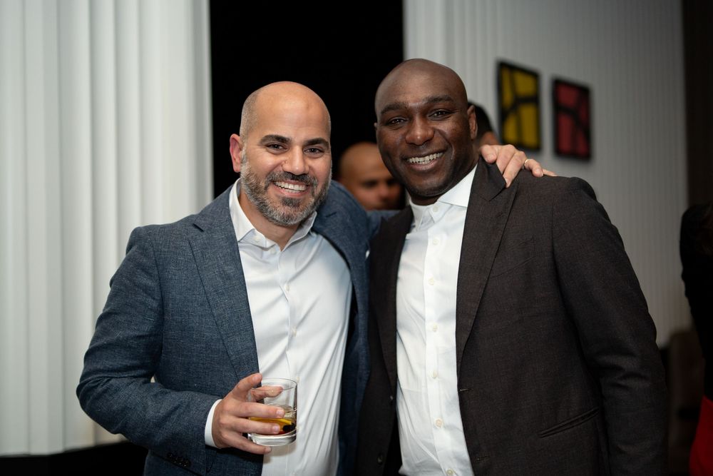 Two men celebrate in formal attire at a 40th birthday party at Boston’s Four Season’s Hotel, photographed by Leah Ramuglia Photography.