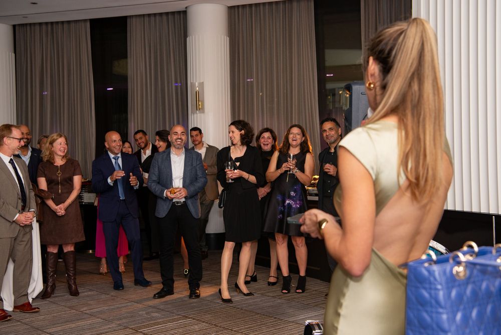 A woman sings to the crowd at a 40th Birthday Party at the Four Season’s One + One Restaurant with Leah Ramuglia Photography in Boston, MA.