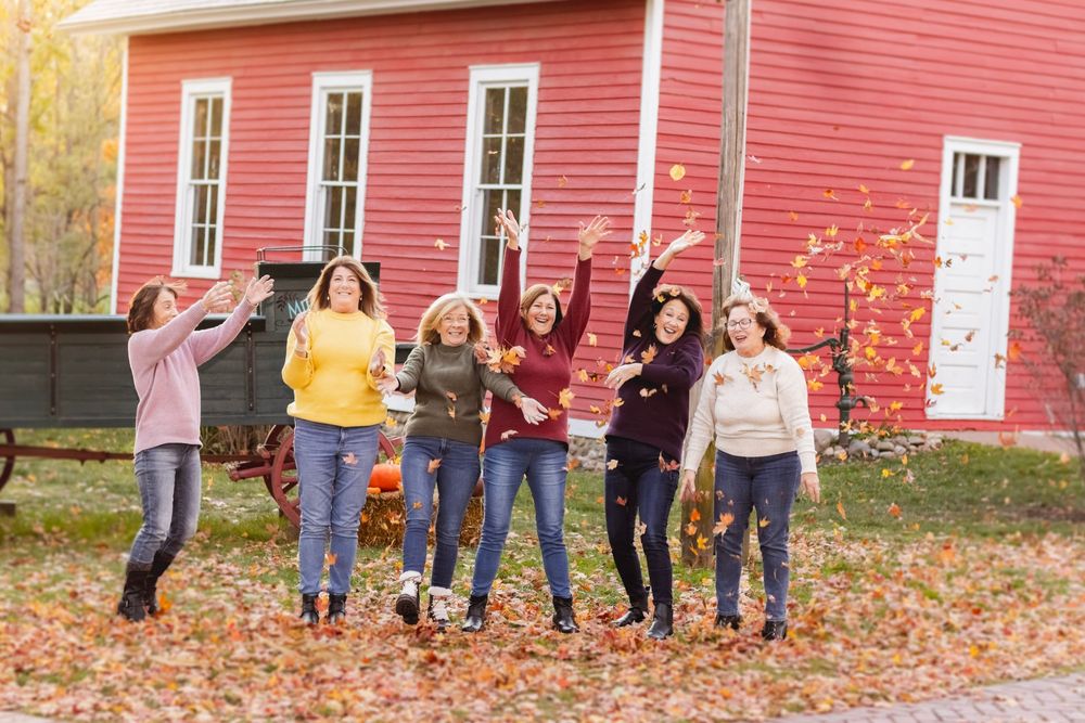 Six women throwing up leaves