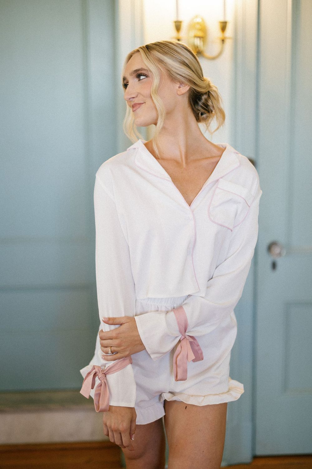 Getting ready scene with white silk robes against pale blue walls.