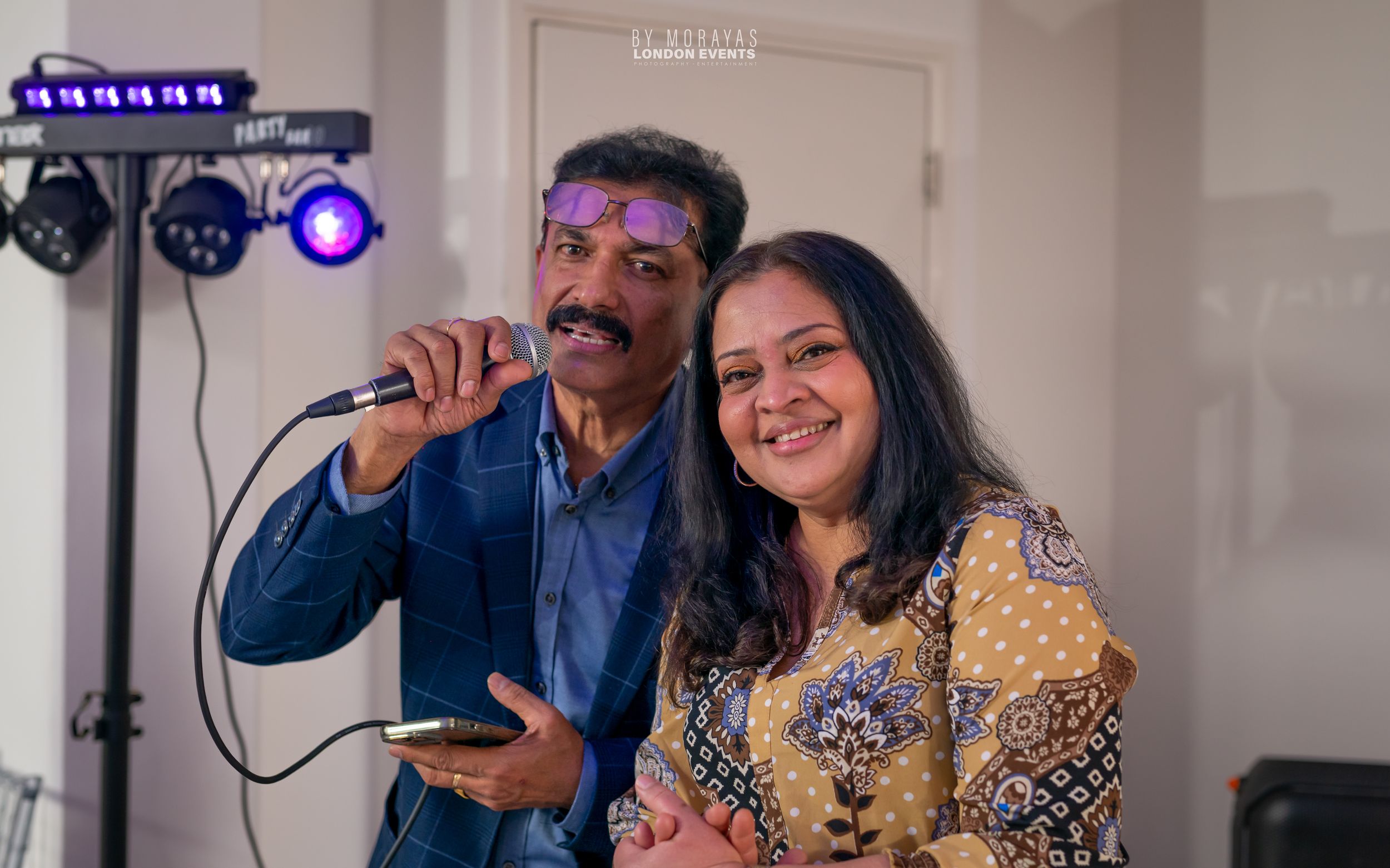 Lively party scene with stage lighting and performers entertaining guests.