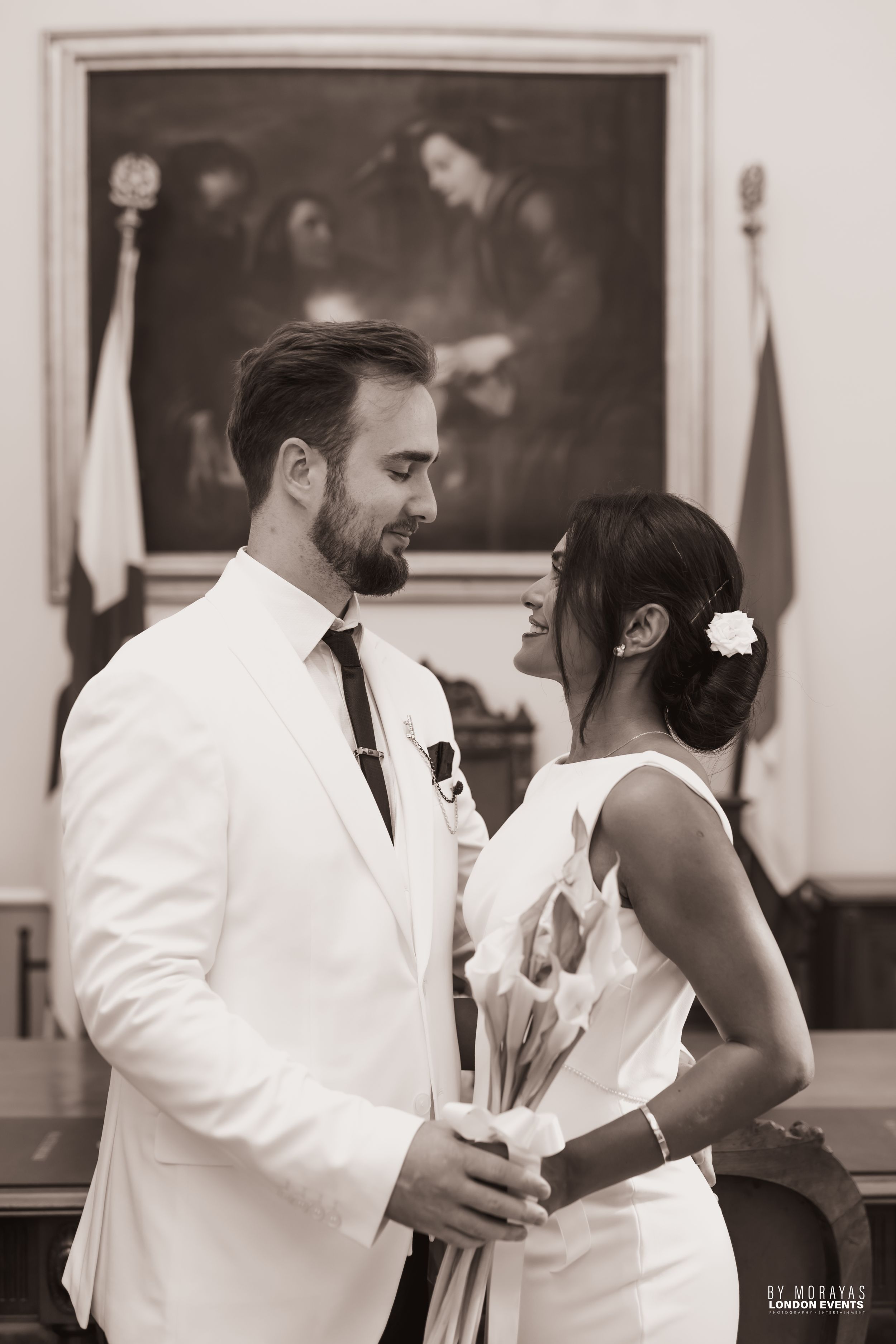 A romantic first dance moment between newlyweds in black and white at their wedding reception.