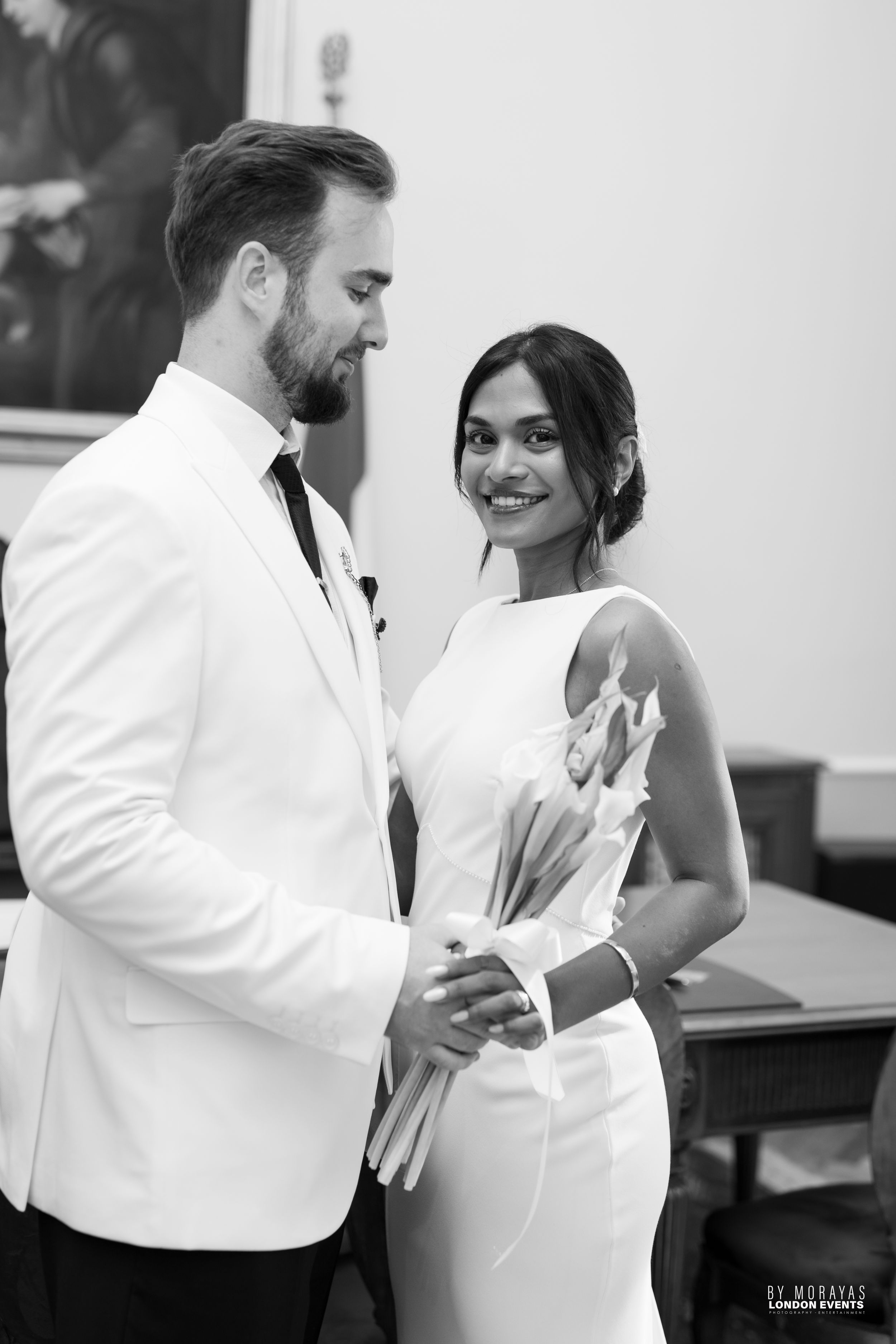 Black and white photos capturing candid moments between dancing newlyweds.