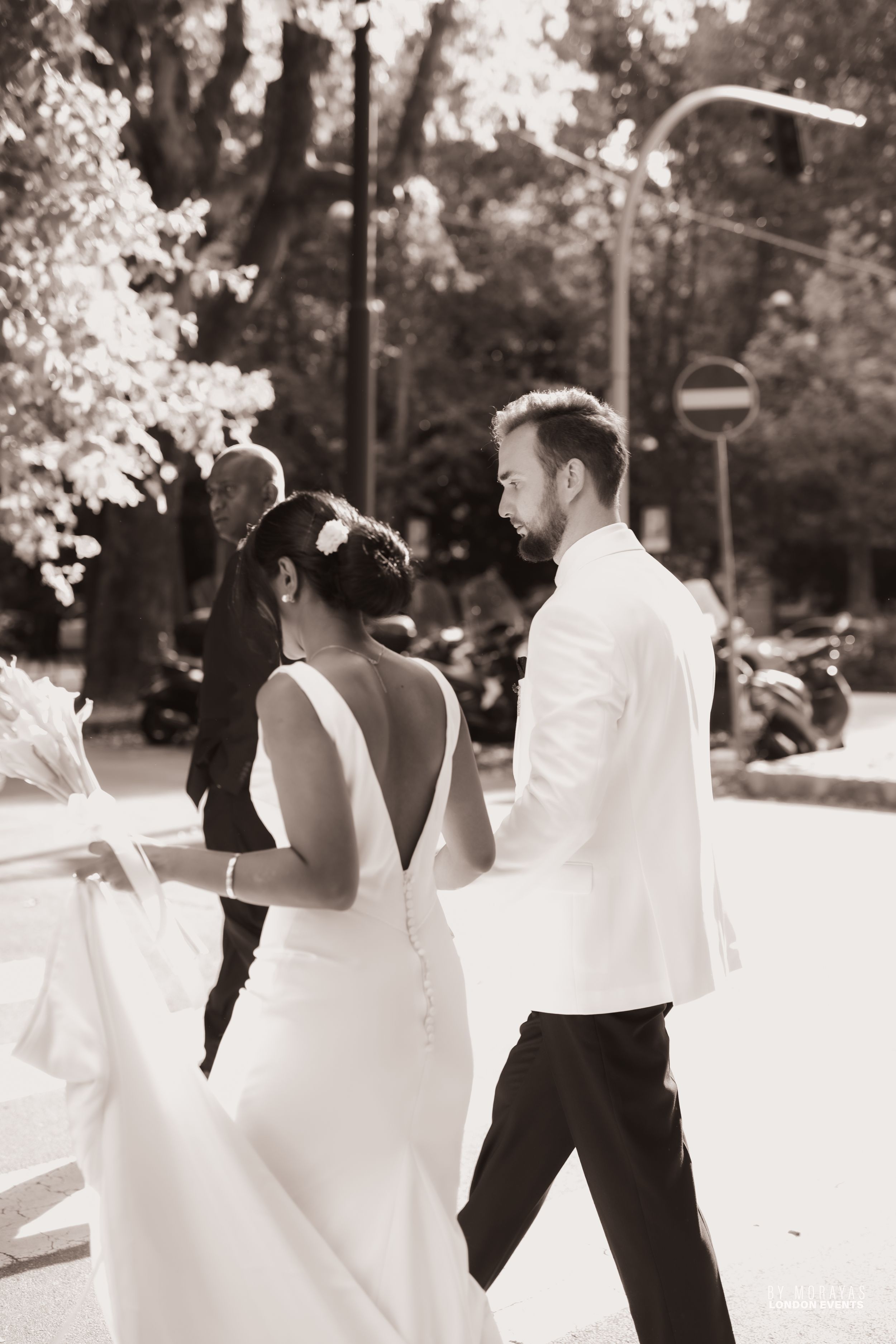 Wedding couple dancing outdoors surrounded by soft bokeh lighting effects.